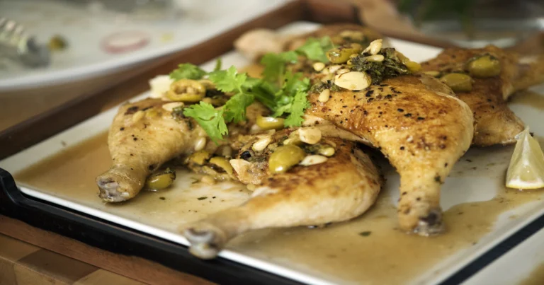 Slow-cooked chicken smothered in creamy gravy inside a crockpot, ready to serve with mashed potatoes or rice.