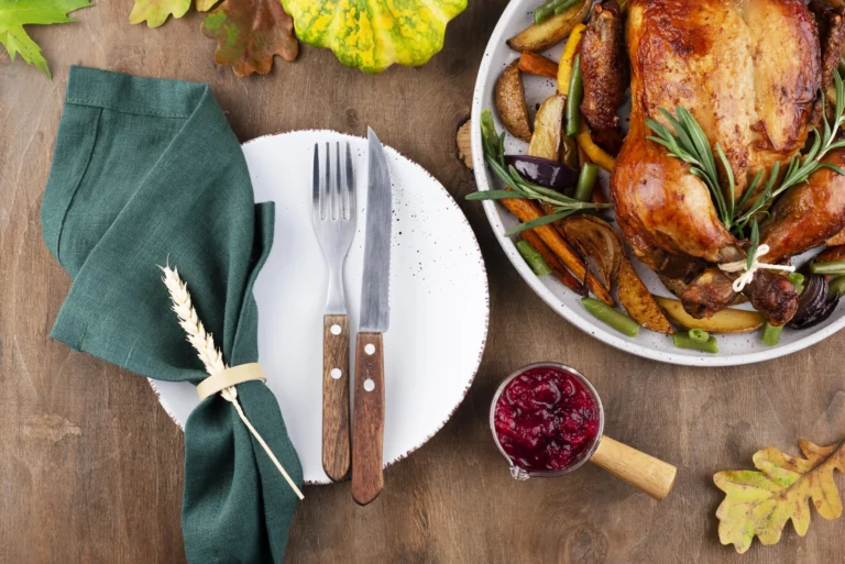 Juicy oven-roasted turkey legs on a rustic wooden platter with herbs and vegetables